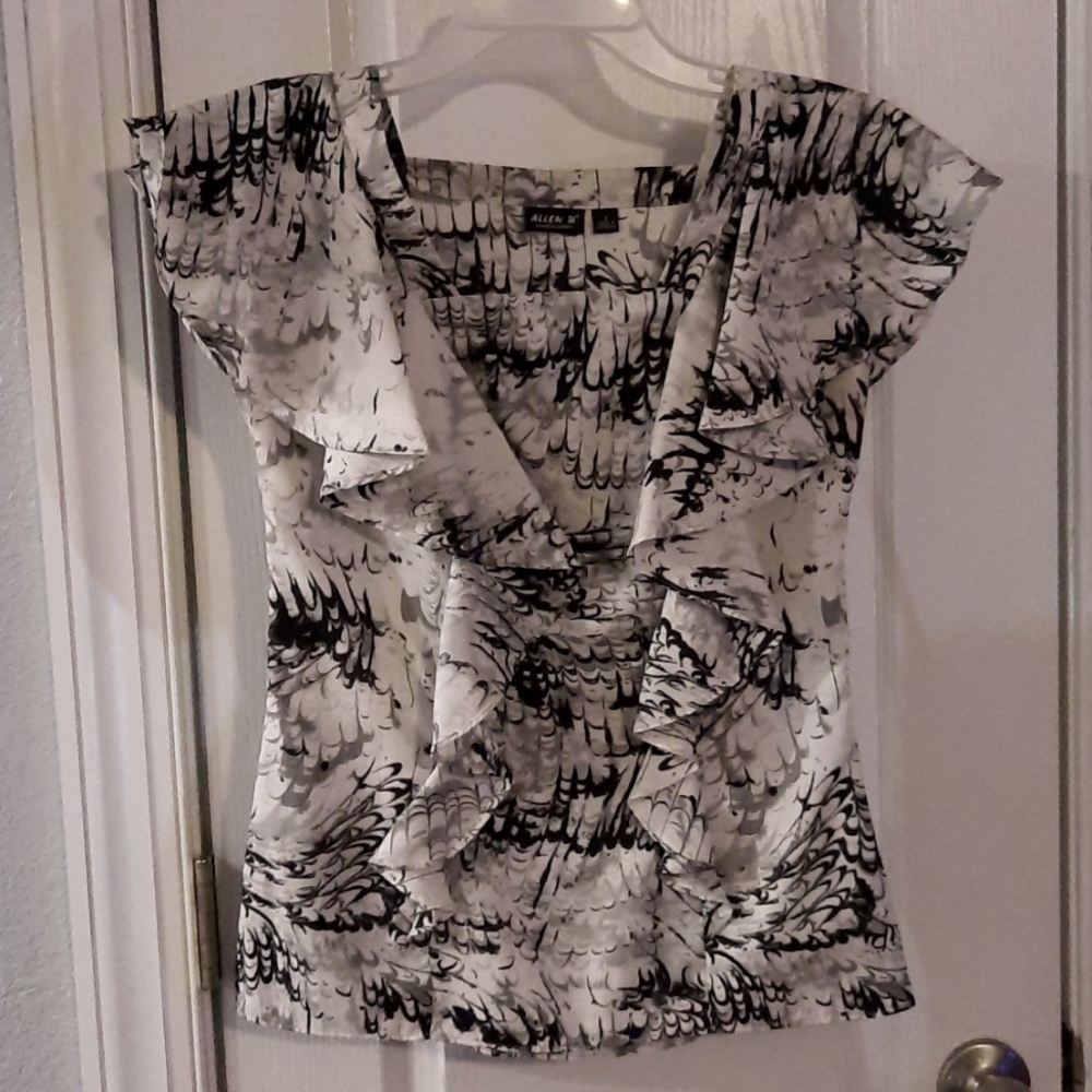 Black, white,and grey side zip top with ruffles on front and back.
